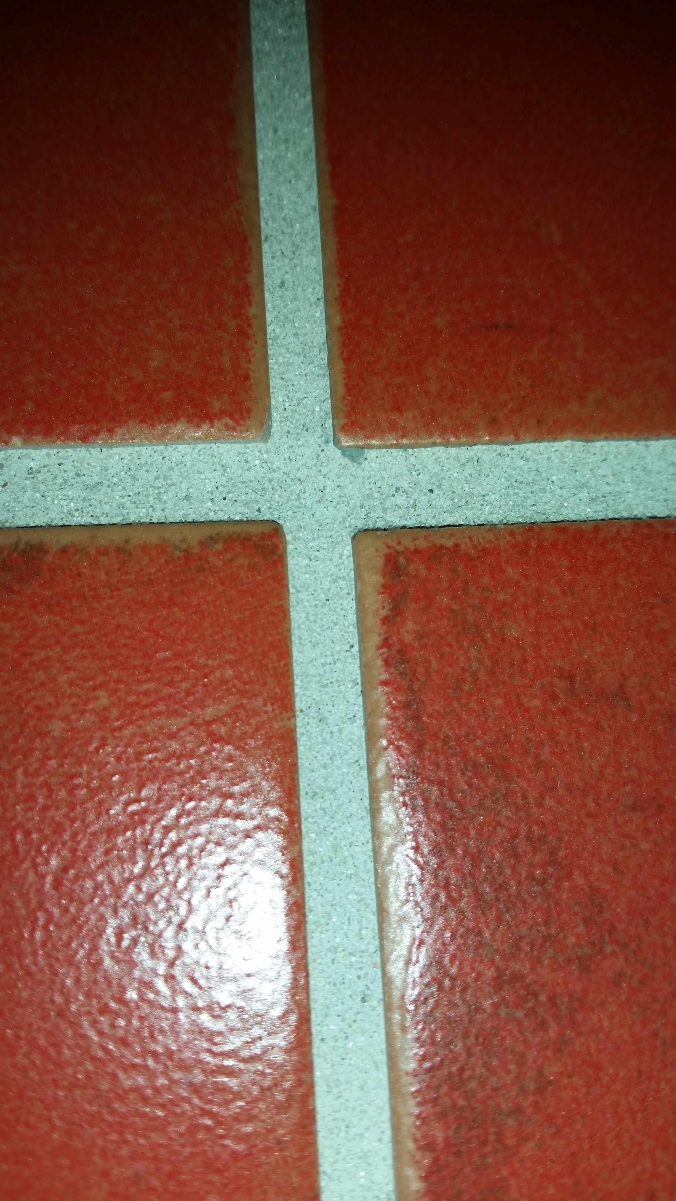 Red tiles with clean restored grout after recolouring