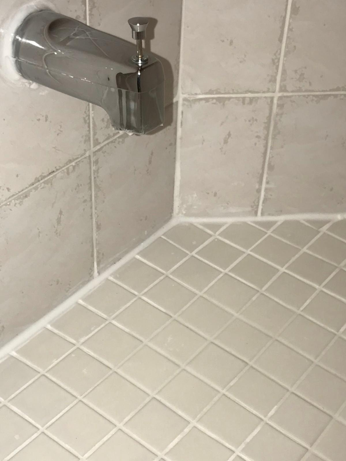 Faucet-side corner after restoration — clean white grout and silicone joints — TilesRus