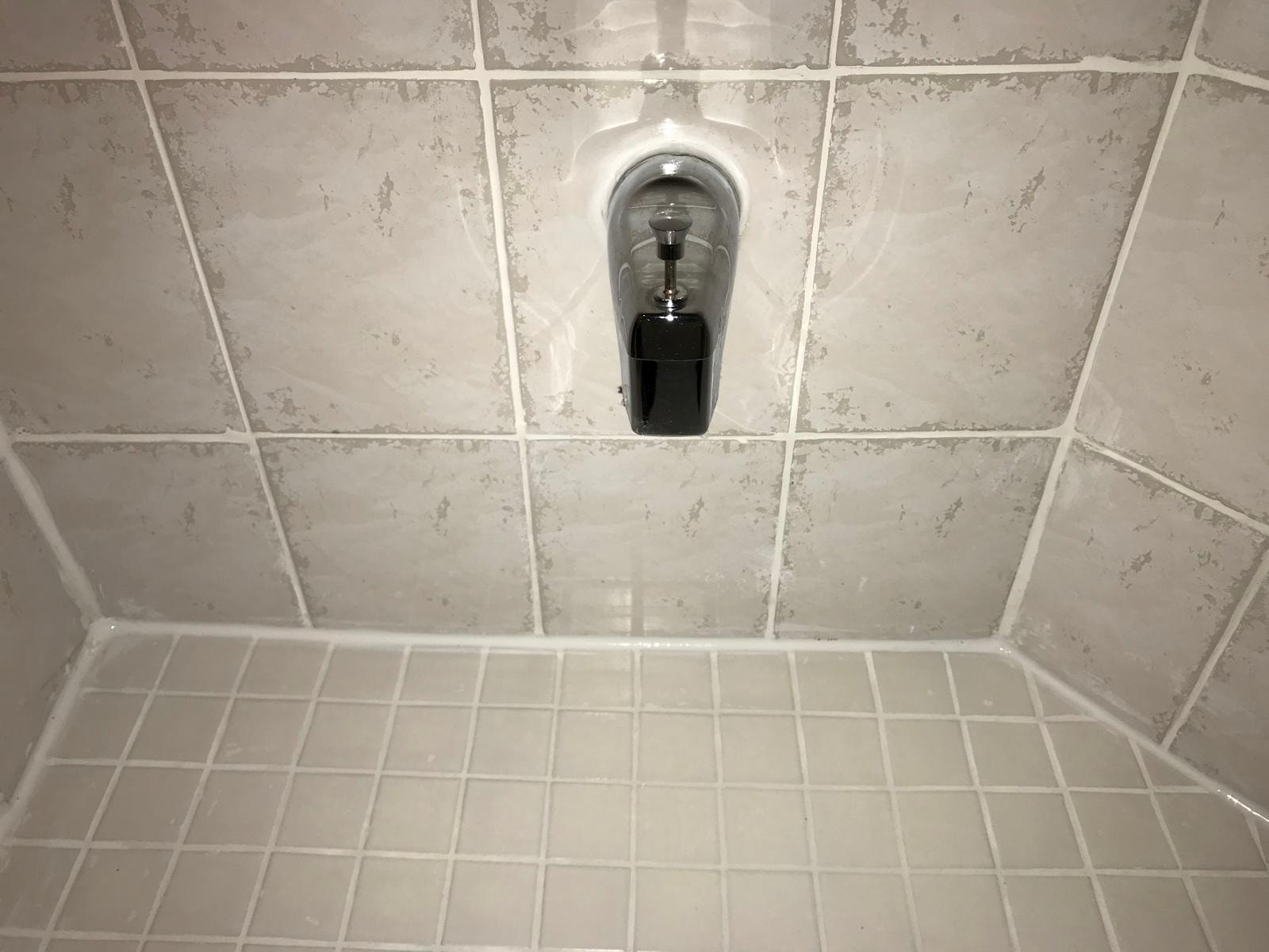 Lower wall and floor joint after restoration — clean grout and silicone — TilesRus