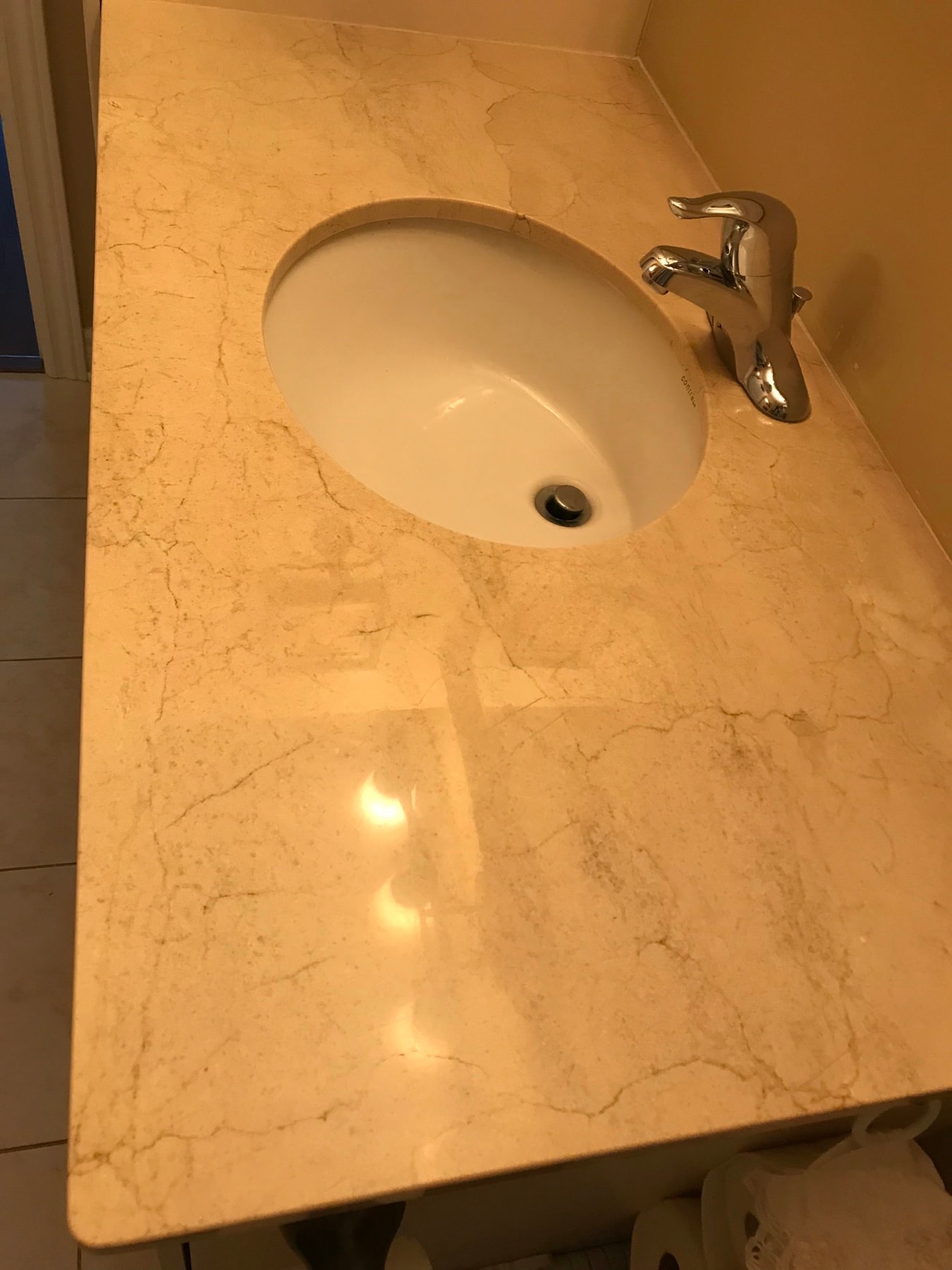 Marble bathroom vanity countertop and sink after polishing — restored reflection