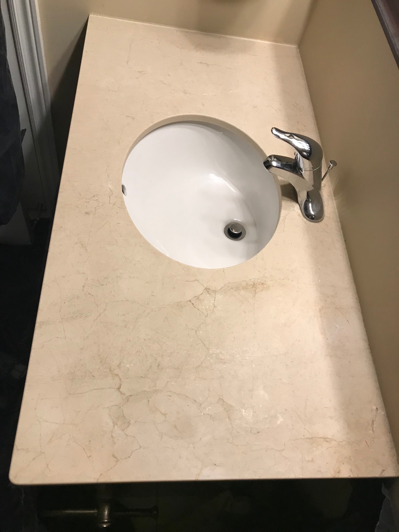 Marble bathroom vanity countertop and sink before polishing — dull surface